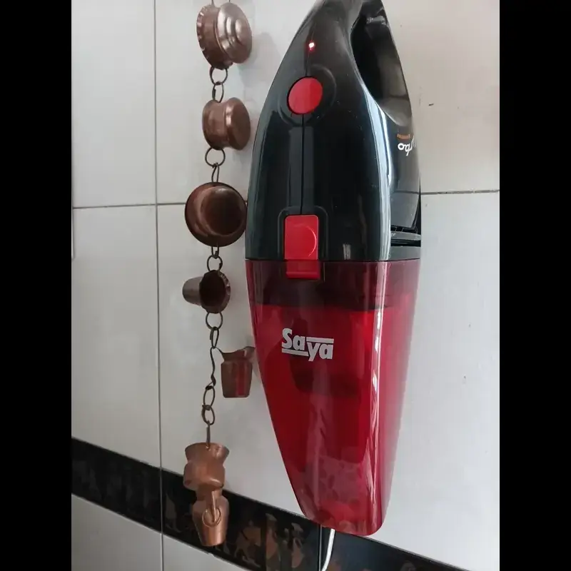 جارو شارژی دستی سایا مدل توربو Turbo رنگ مشکی قرمز روی دیوار نصب شده